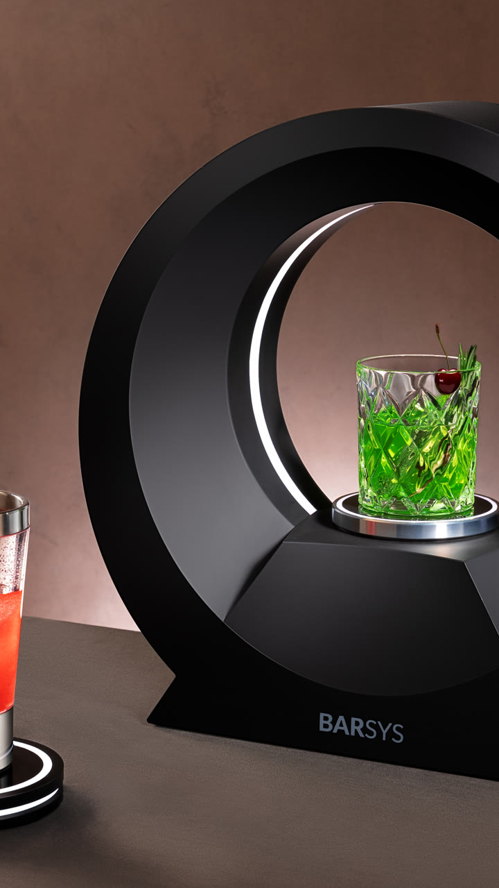 A Barsys 360 with a bright green cocktail in a cut-glass tumbler.