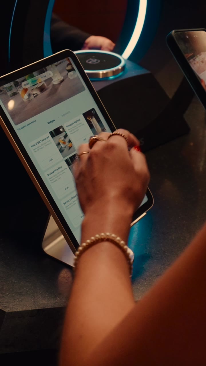 A guest choosing a drink on the Barsys tablet at a New York event.