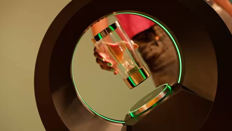 A Barsys 360 being loaded: a hand pours spirit into one of the six canisters.